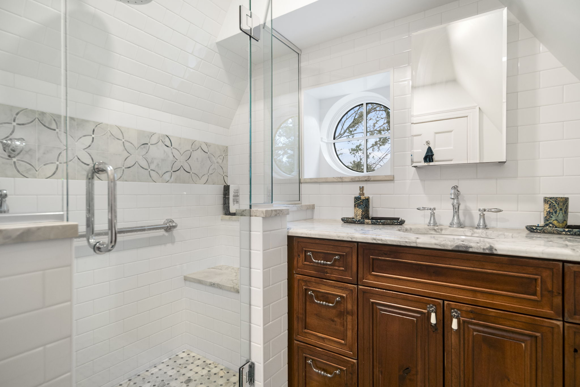 Remodeled white bathroom with dark wood cabinet in the Cayuga Heights neighborhood of Ithaca NY