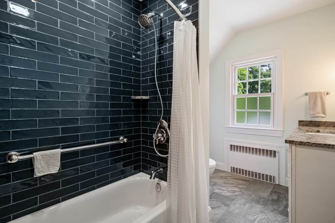Bathroom in North Ithaca with blue tile tub surround