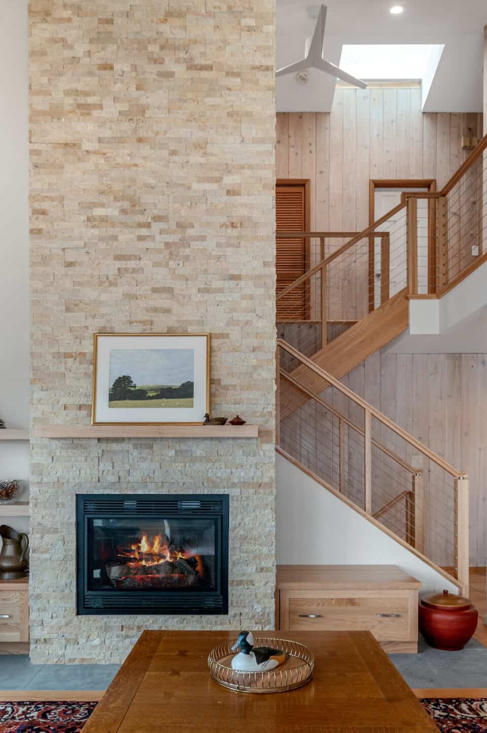 Two-story stone chimney in living room