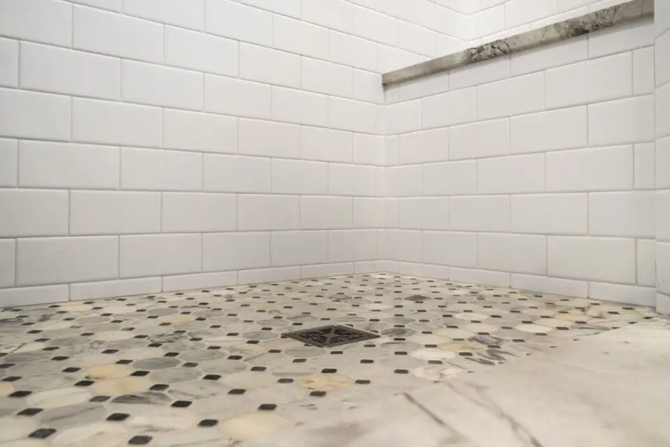 Decorative tile floor in bathroom shower with drain