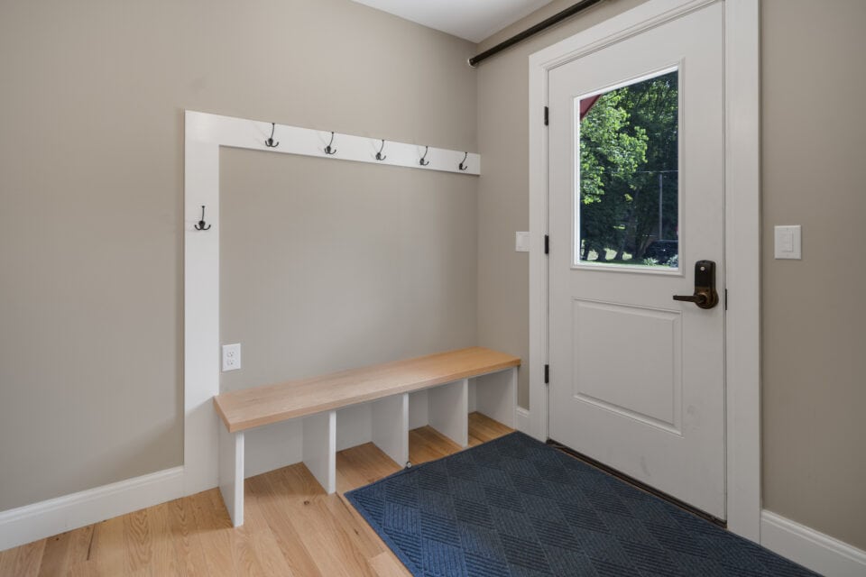 Mud room entrance with bench and storage