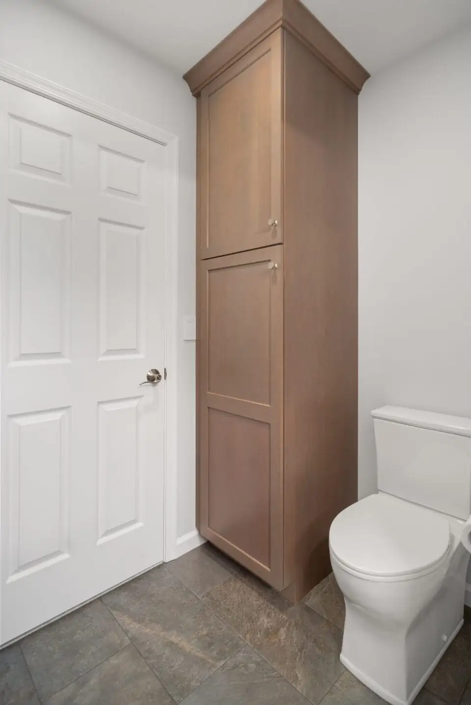 Floor-to-ceiling storage cabinet in bathroom