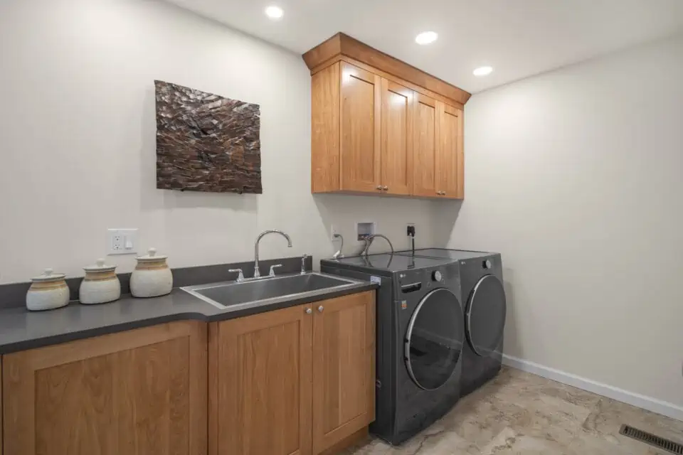 Laundry room with quartz countertops and custom cabinetry