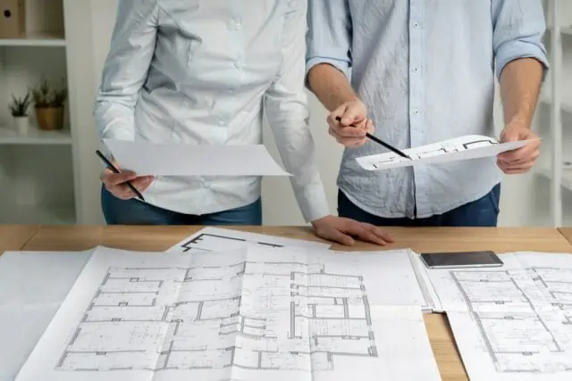 Design professionals looking at a set of plans for a remodel